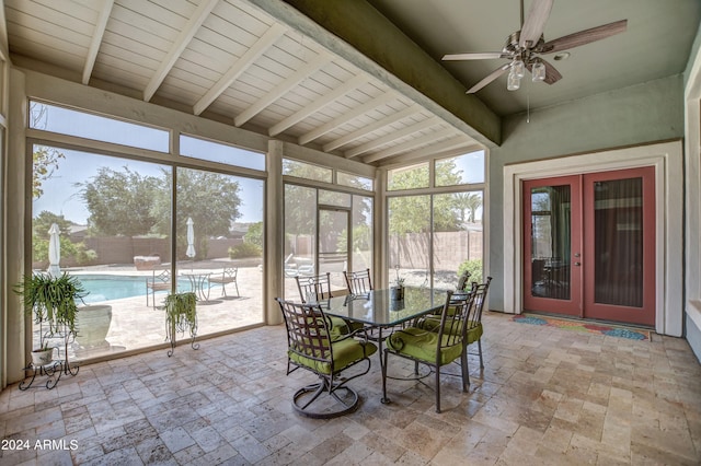 unfurnished sunroom with french doors, lofted ceiling with beams, and ceiling fan