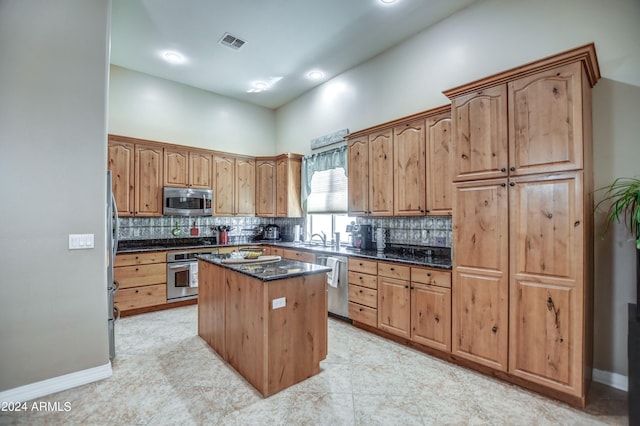 kitchen featuring tasteful backsplash, visible vents, appliances with stainless steel finishes, and a kitchen island