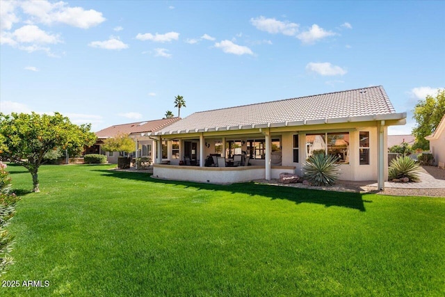 rear view of property featuring a yard