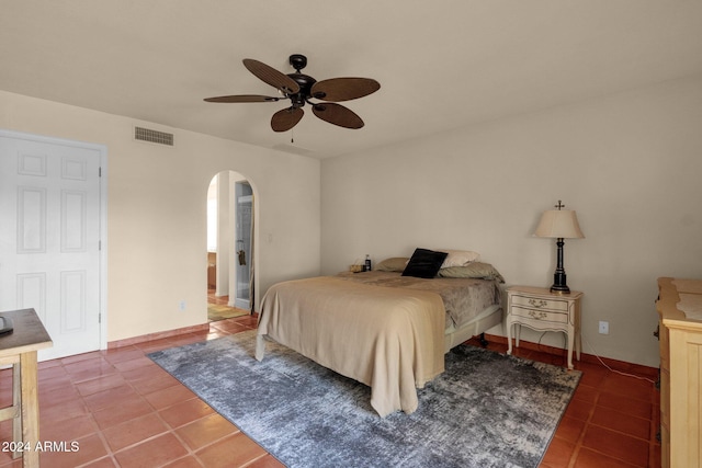 bedroom featuring dark tile patterned flooring and ceiling fan