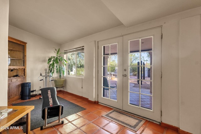 doorway to outside with french doors and light tile patterned floors