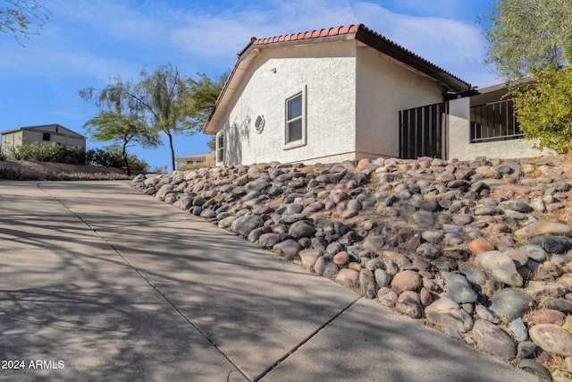 view of side of property with a patio area