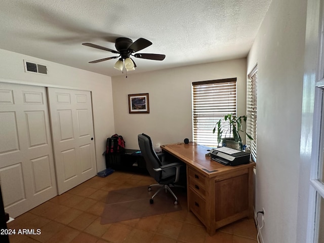 office area featuring a textured ceiling, ceiling fan, and light tile patterned floors