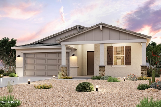 39980 W Sparks Ln, Maricopa, AZ 85138 - view of front facade with driveway, board and batten siding, an attached garage, stucco siding, and stone siding