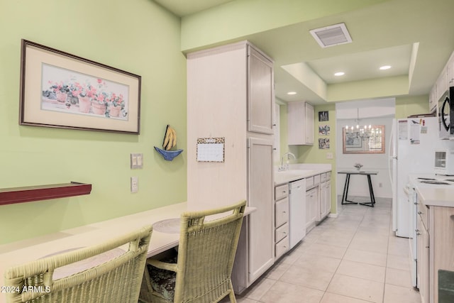 kitchen with sink, white cabinetry, dishwasher, light tile patterned floors, and a notable chandelier