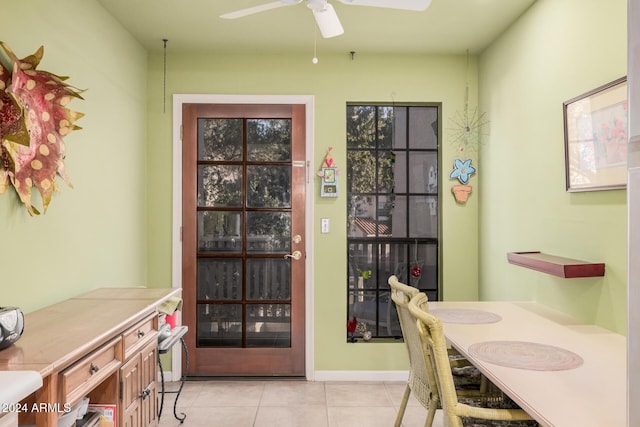 dining space featuring ceiling fan and light tile patterned floors