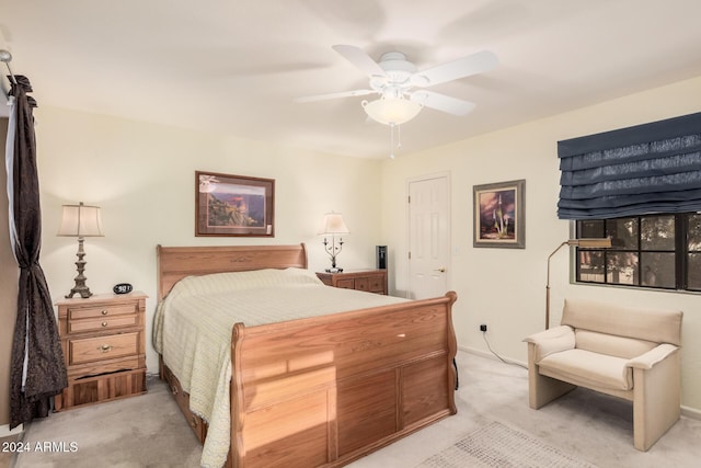 bedroom featuring light colored carpet and ceiling fan