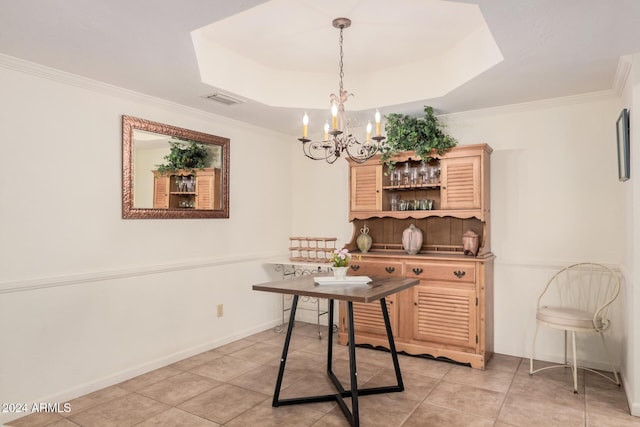 tiled dining area with a raised ceiling, a chandelier, and ornamental molding