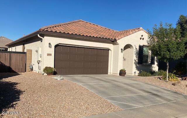 mediterranean / spanish home with a garage