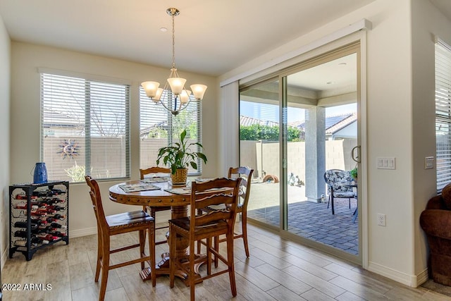 dining area with a chandelier and light hardwood / wood-style floors