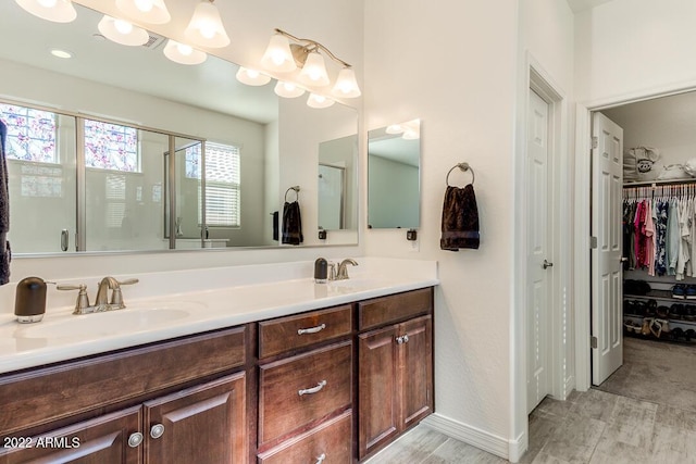 bathroom with vanity, wood-type flooring, and walk in shower