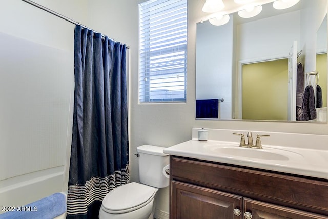 full bathroom with vanity, shower / bath combo, and toilet