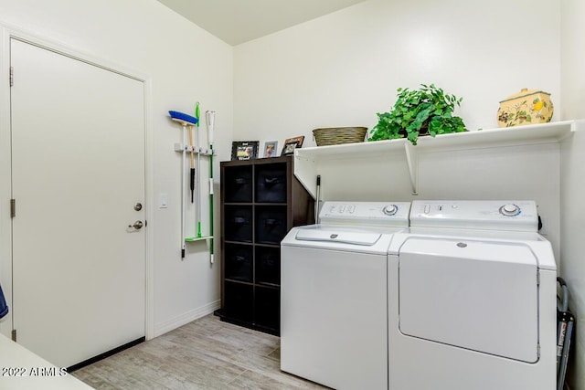 washroom featuring washer and clothes dryer and light hardwood / wood-style flooring