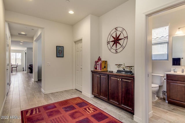 corridor with light hardwood / wood-style flooring