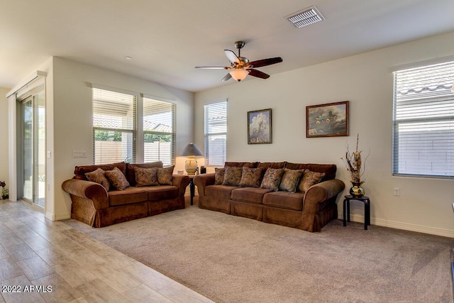 living room with light colored carpet and ceiling fan