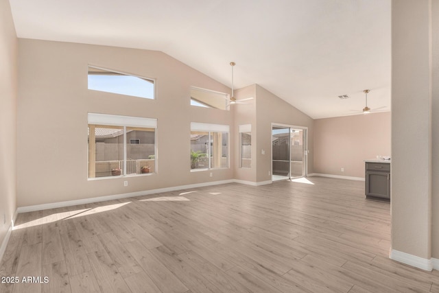 unfurnished living room with light wood finished floors, baseboards, high vaulted ceiling, and a ceiling fan