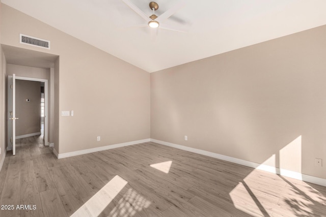 spare room featuring wood-type flooring, ceiling fan, and lofted ceiling