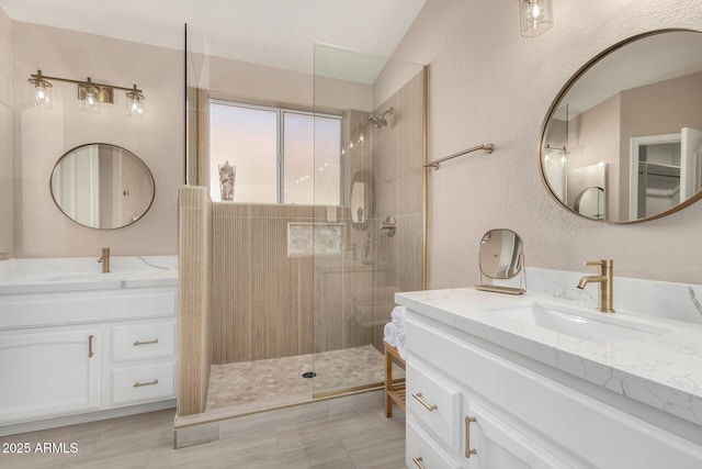 bathroom with vanity and a tile shower