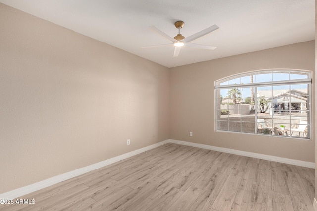 empty room with ceiling fan and light hardwood / wood-style floors