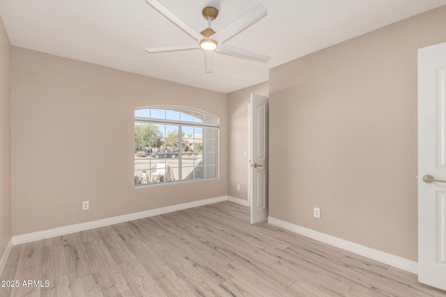 unfurnished room with a ceiling fan, baseboards, and light wood finished floors