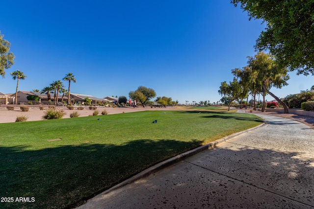 view of property's community featuring a lawn