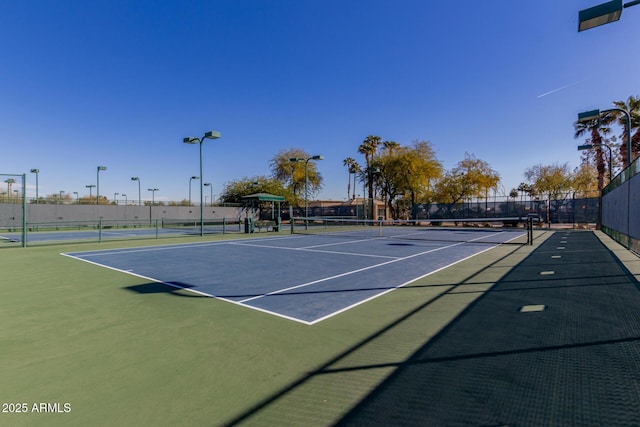 view of tennis court with fence