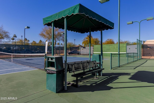 view of tennis court with fence