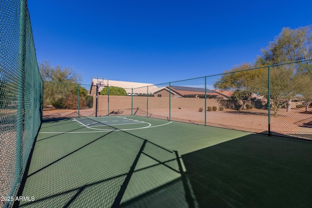 view of basketball court with community basketball court and fence