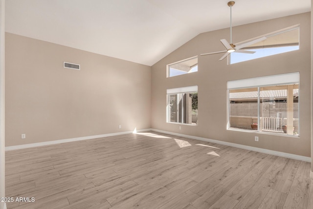 unfurnished room with ceiling fan, high vaulted ceiling, and light wood-type flooring