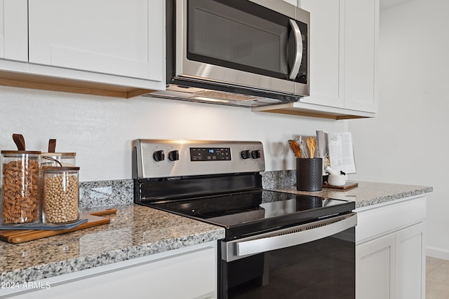 28242 N Nealite Dr, San Tan Valley, AZ 85143 - kitchen with stainless steel appliances, white cabinetry, and light stone countertops