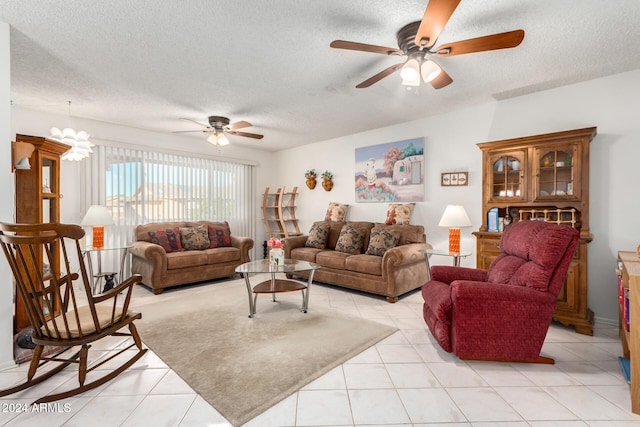 living room featuring ceiling fan, a textured ceiling, and light tile patterned floors