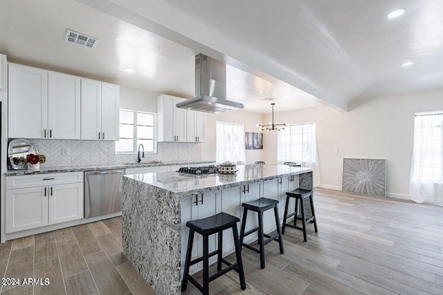 kitchen featuring white cabinets, a center island, and stainless steel appliances