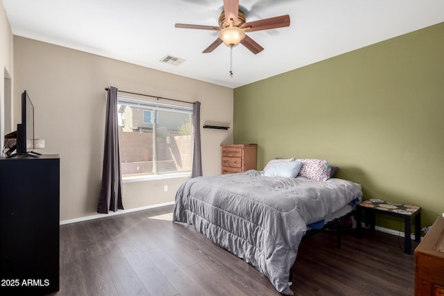 bedroom featuring visible vents, ceiling fan, baseboards, and wood finished floors