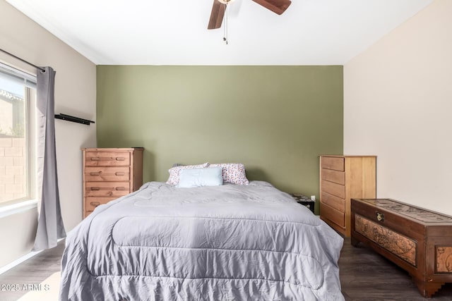 bedroom featuring wood finished floors and a ceiling fan