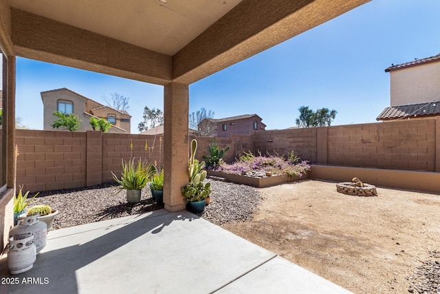 view of patio with a fire pit and a fenced backyard