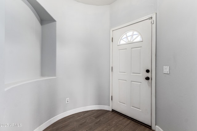 foyer entrance featuring dark wood-style floors and baseboards