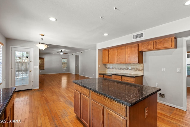 2024 N 125th Ave, Avondale, AZ 85392 - kitchen featuring brown cabinets, light wood-style floors, tasteful backsplash, recessed lighting, and ceiling fan