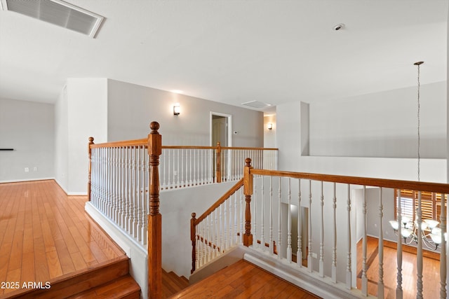 2024 N 125th Ave, Avondale, AZ 85392 - hall featuring hardwood / wood-style flooring, an upstairs landing, and a chandelier