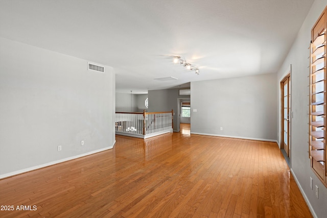 2024 N 125th Ave, Avondale, AZ 85392 - unfurnished living room featuring light wood-type flooring and rail lighting