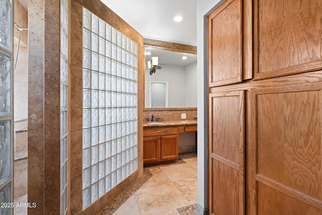 2024 N 125th Ave, Avondale, AZ 85392 - full bathroom featuring vanity, a tile shower, recessed lighting, and stone finish floors