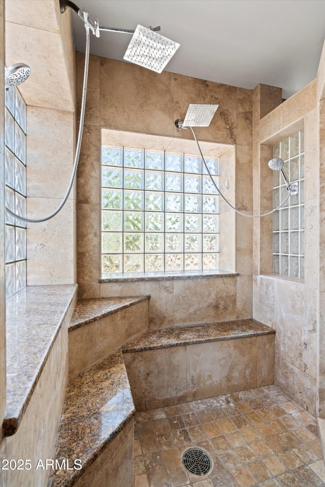 2024 N 125th Ave, Avondale, AZ 85392 - bathroom featuring tiled shower, plenty of natural light, and stone tile floors