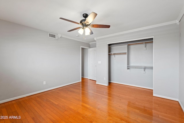 2024 N 125th Ave, Avondale, AZ 85392 - unfurnished bedroom featuring crown molding, a closet, light wood-type flooring, and a ceiling fan