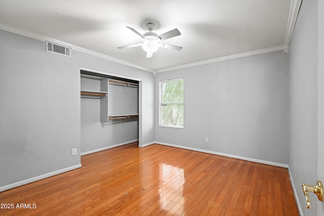 2024 N 125th Ave, Avondale, AZ 85392 - unfurnished bedroom featuring ornamental molding, a closet, hardwood / wood-style flooring, and a ceiling fan