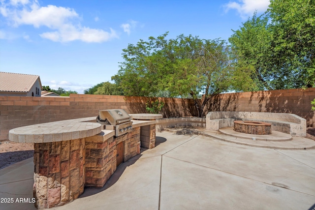 2024 N 125th Ave, Avondale, AZ 85392 - view of patio with a fire pit and exterior kitchen