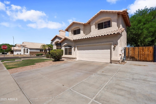 2024 N 125th Ave, Avondale, AZ 85392 - mediterranean / spanish-style home with stucco siding, driveway, a tiled roof, and an attached garage