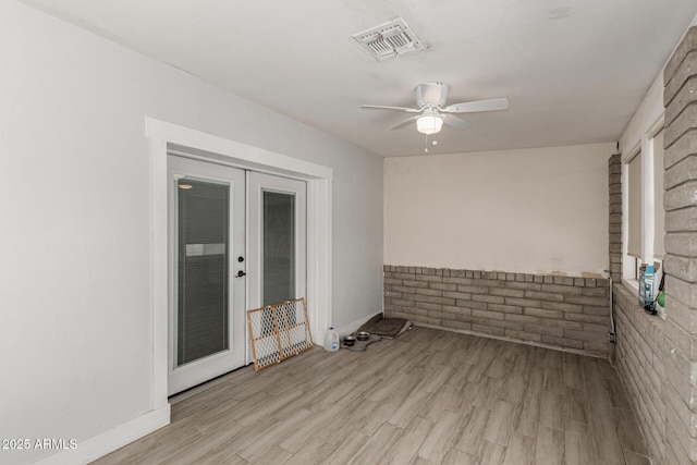 505 S S Rdg, Mesa, AZ 85204 - spare room featuring french doors, ceiling fan, light wood finished floors, and brick wall