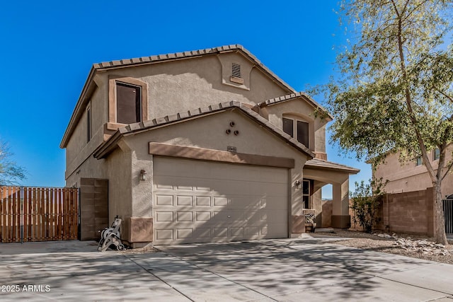 mediterranean / spanish home featuring fence, a tile roof, concrete driveway, stucco siding, and an attached garage