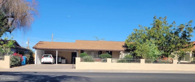 ranch-style home featuring a carport