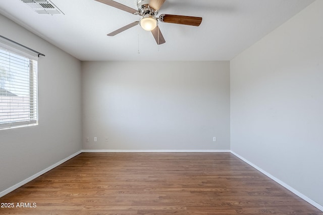 16077 W Larkspur Dr, Goodyear, AZ 85338 - spare room with wood finished floors, ceiling fan, and baseboards