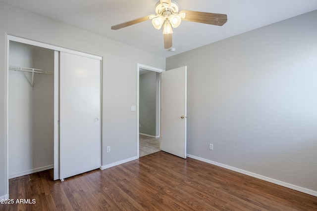 16077 W Larkspur Dr, Goodyear, AZ 85338 - unfurnished bedroom featuring wood finished floors, baseboards, a closet, and ceiling fan